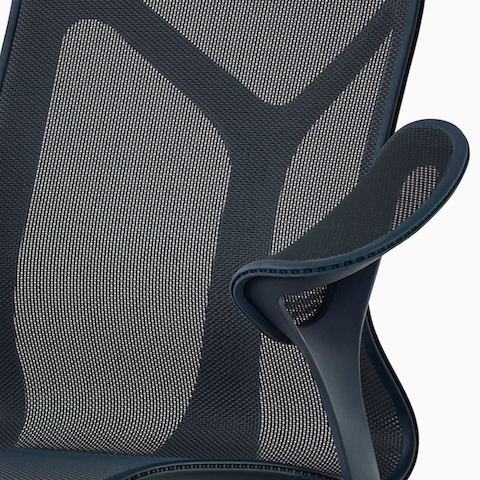A close up of a Nightfall navy blue Cosm chair with leaf arms.