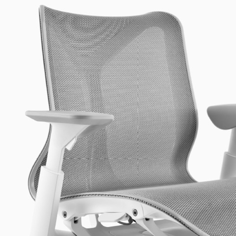A low-back Cosm Chair with height-adjustable arms, and Studio White frame and Mineral suspension material.