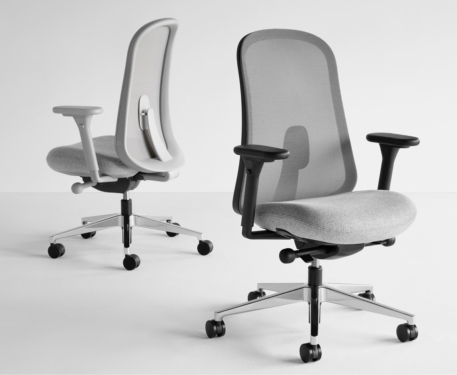 Two black and grey Lino Chairs with adjustable sacral lumbar support, viewed from the front and back at angles.
