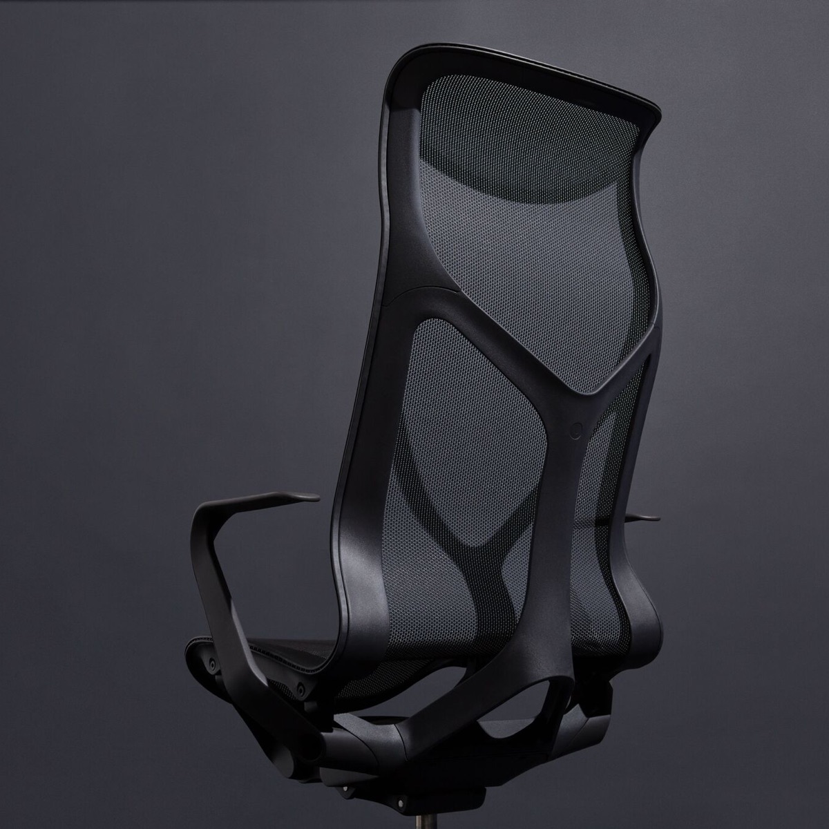 A Graphite dark grey Cosm high-back ergonomic desk chair with fixed arms on a dark grey background.
