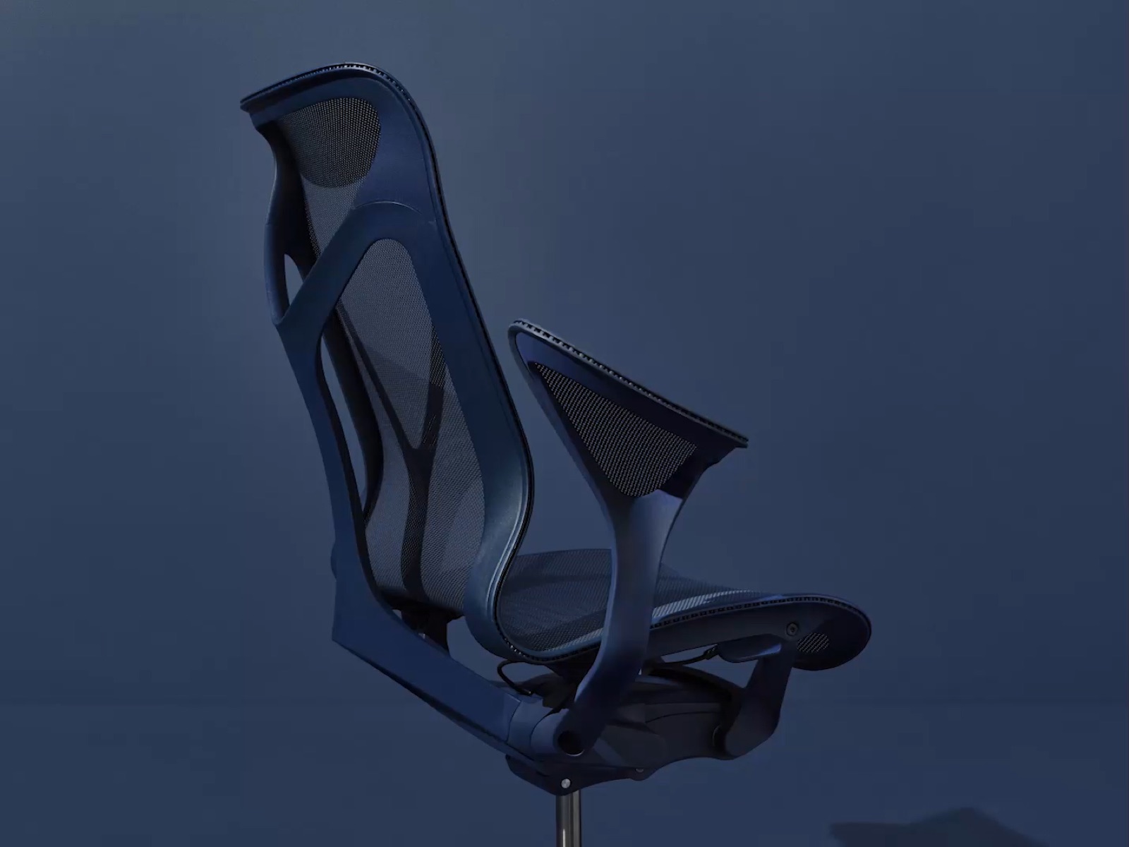 A high-back Cosm office chair with leaf arms in Nightfall dark blue, viewed from an angle.